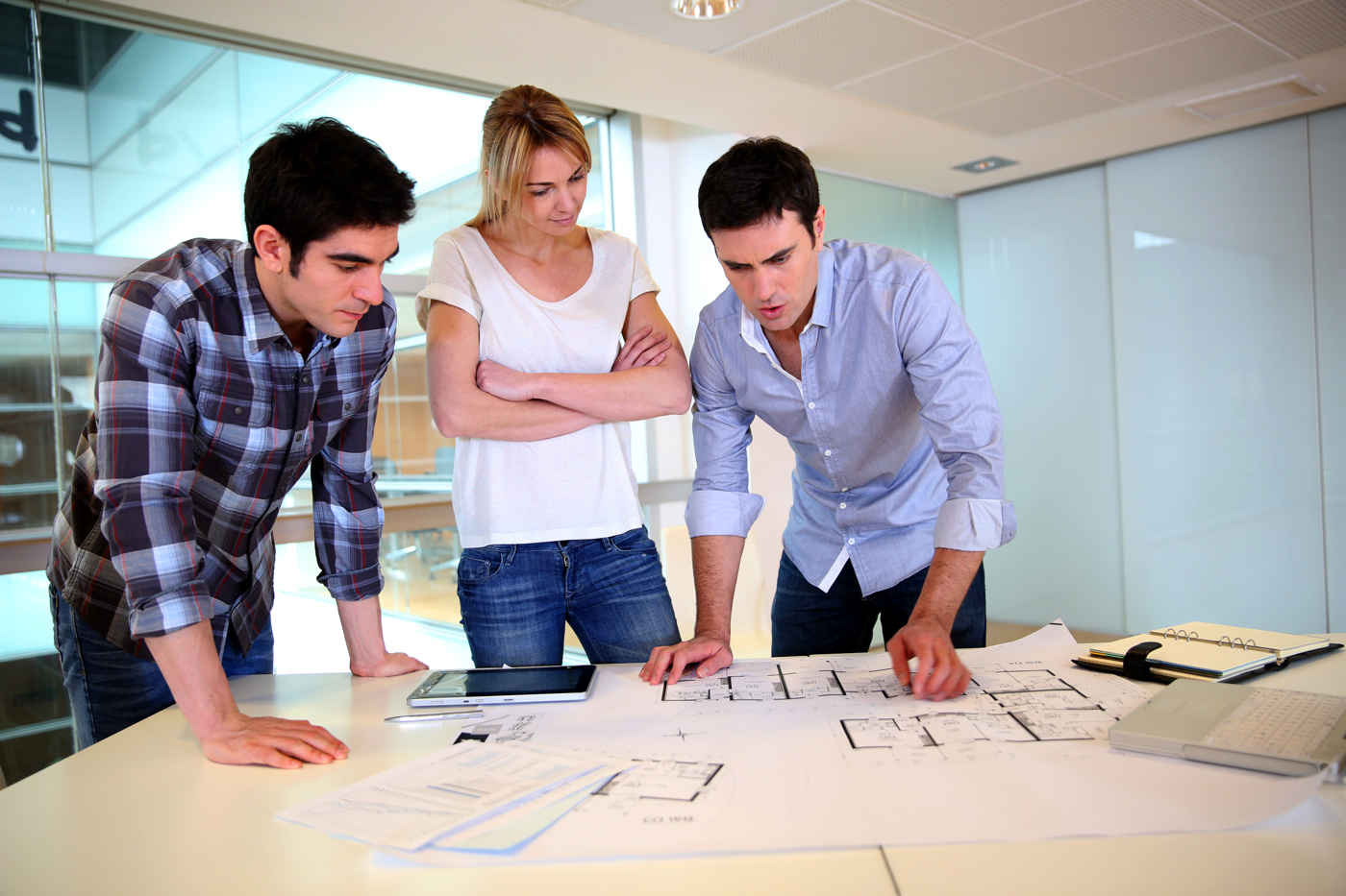 Ein junges Architekten-Team bespricht Baupläne