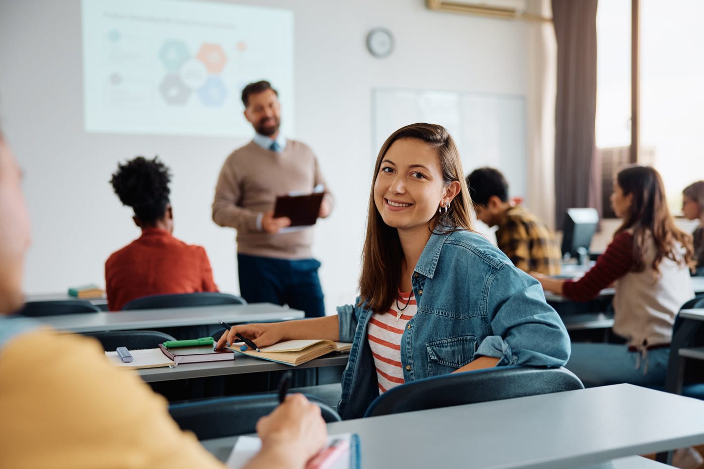 Frau möchte Matura nachholen und sitzt dafür im Unterricht einer Maturitätsschule für Erwachsene.