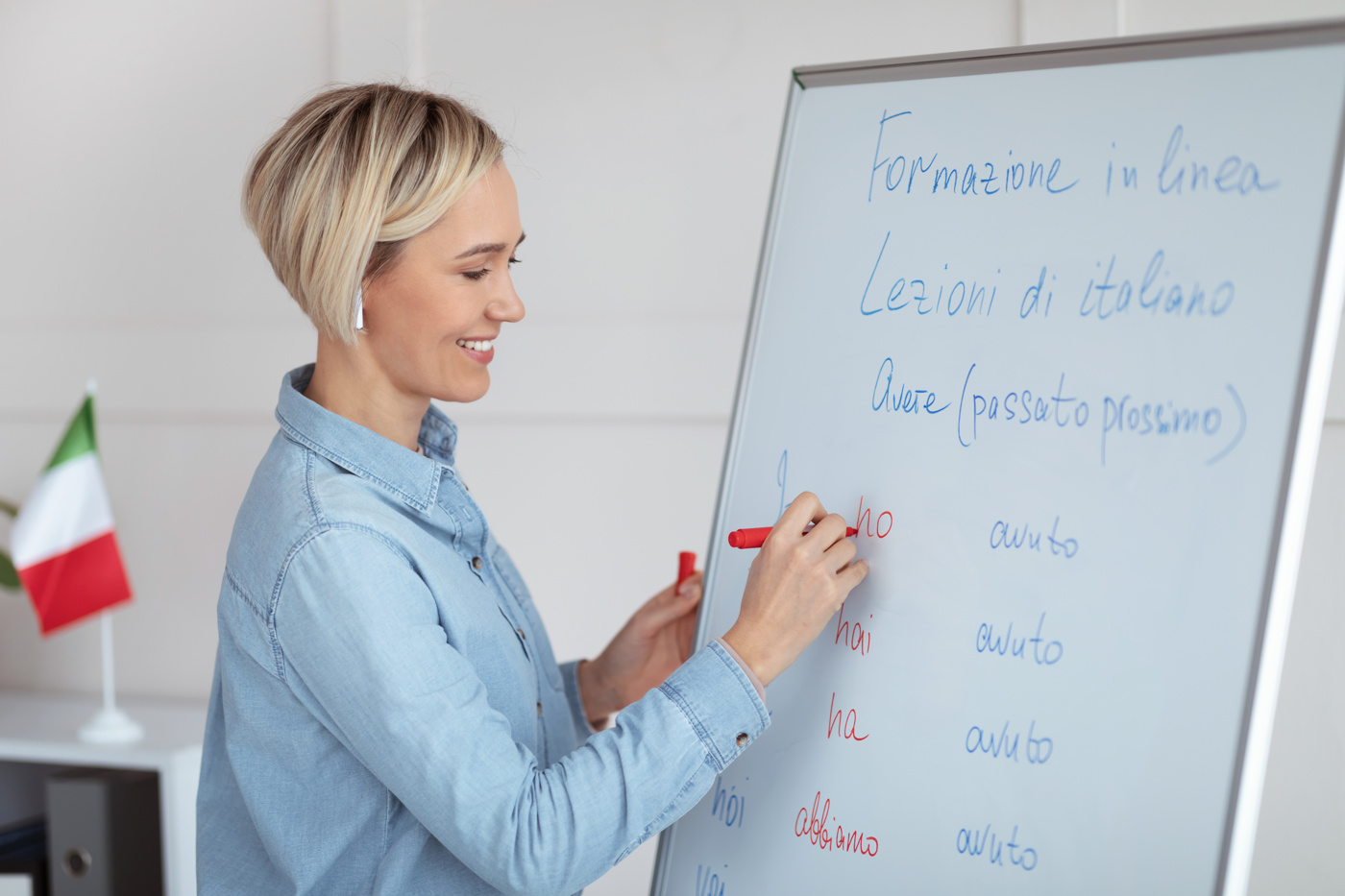 Eine Italienisch-Lehrerin schreibt etwas an das Whiteboard.